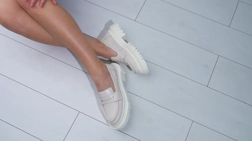 Woman Wearing Stylish Platform Loafers Sitting on Floor