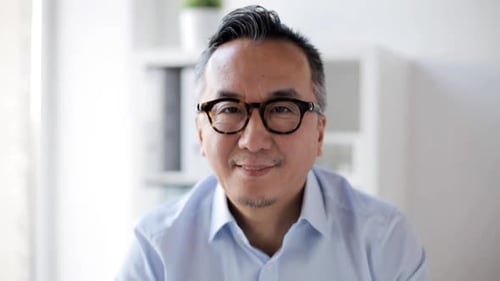 Happy Asian Businessman Smiling at Office