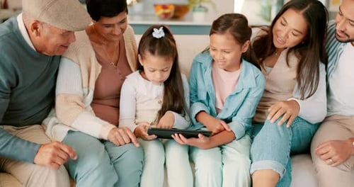 Family Sharing Tablet Together on Couch
