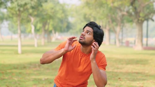 Man Looking Anxious in Park, Looking Around
