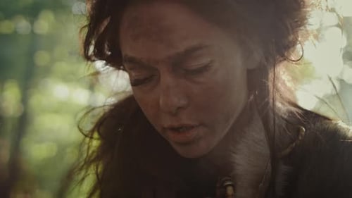 Prehistoric Cave Woman Handles Animal Skins, Furs and Hides. Primitive Neanderthal Woman Lifestyle