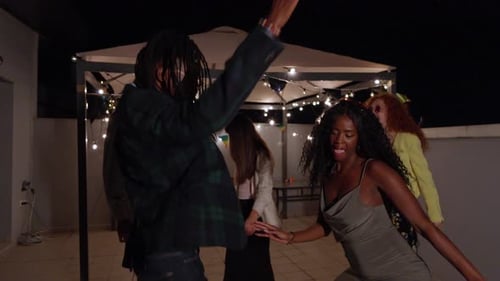 Friends Dancing at Nighttime Outdoor Party