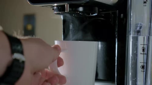 Slow Motion View of Black Coffee Pouring From the Machine to White Cup Fresh Cafe in the Kitchen of