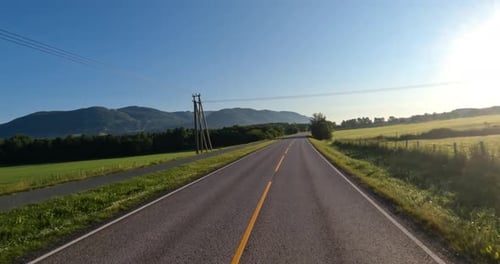 Driving a Car on a Road in Norway.