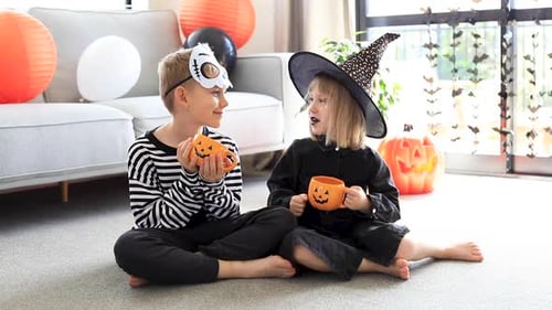 Children Celebrate Halloween with Pumpkin Mugs