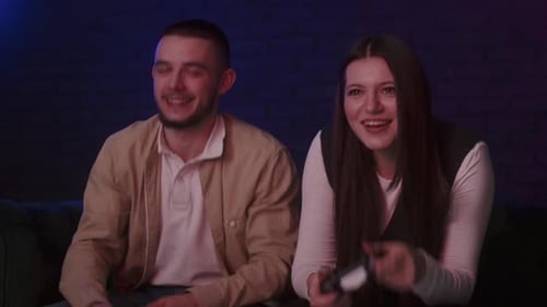 Excited Couple Laughing and Gaming at Home