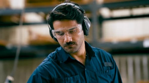 Focused Factory Worker Wearing Safety Gear