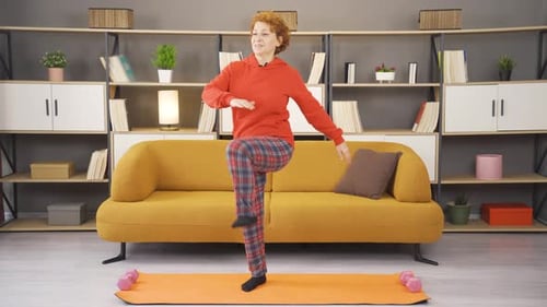 Cheerful and healthy mature woman plays sports.