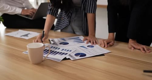 Business Team Analyzes Reports at Office Meeting