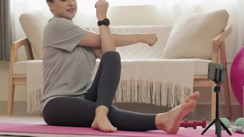 Woman Stretching on Yoga Mat at Home