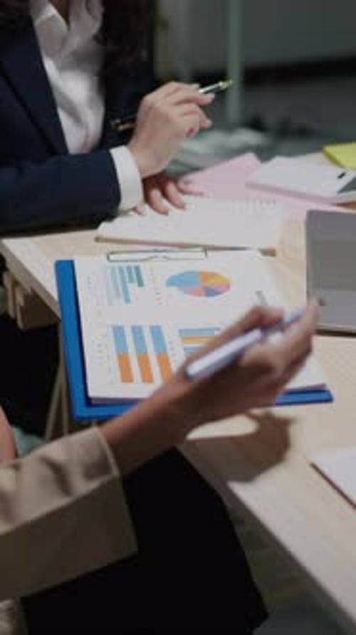 Two People Reviewing Business Documents in the Office