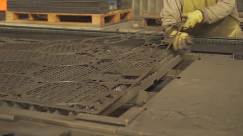 Unrecognizable person working with metal parts steel industrial production. Handheld