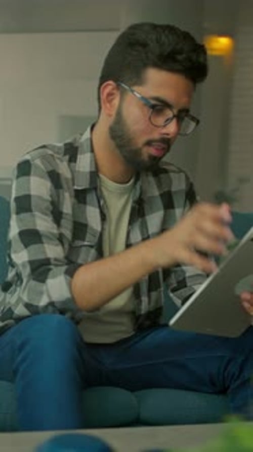 Man Using Tablet Indoors on Bright Day
