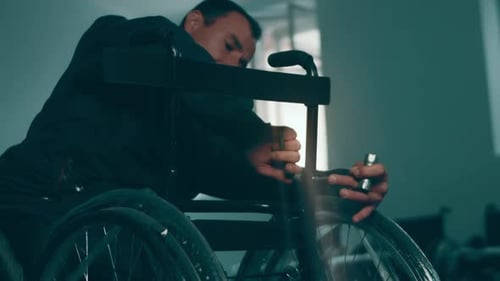 A Disabled Man Assembles a Stroller