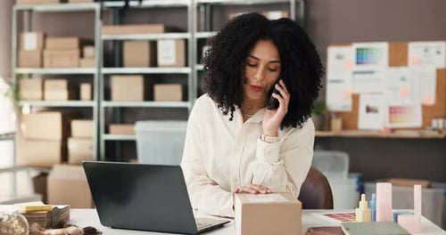 Woman Working at Desk on Laptop and Phone