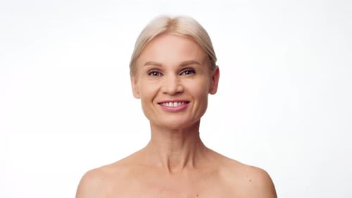 Smiling woman with blonde hair looking into camera