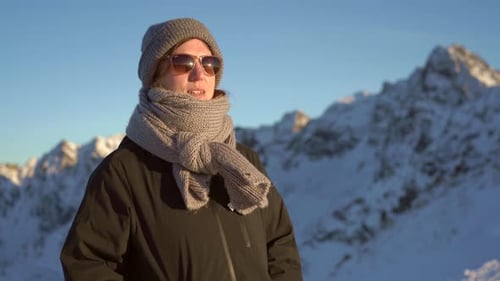 Enjoying the mountain view in winter attire on a sunny day
