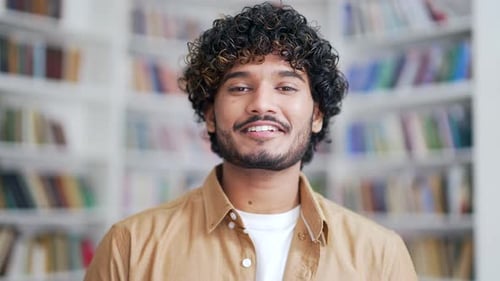 Close up portrait of a young university student smiling and looking at the camera. Happy positive