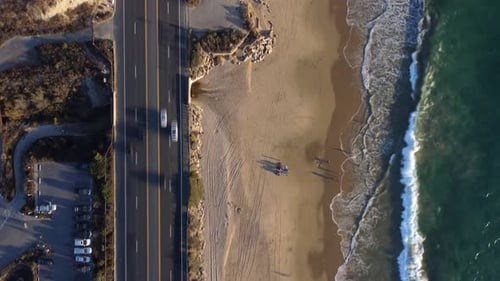 Coastal Highway, Timelapse, Looking Down on Road From Above as Waves Crash on Beach