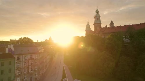 Fiery Sunrise In The Old Town Of Krakow With Wawel Royal Castle In Poland - aerial ascending