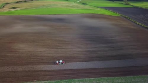 Tractor Plowing Aerial Shot. Drone Footage Of A Tractor Plowing A Field. Countryside Aerial Shot.