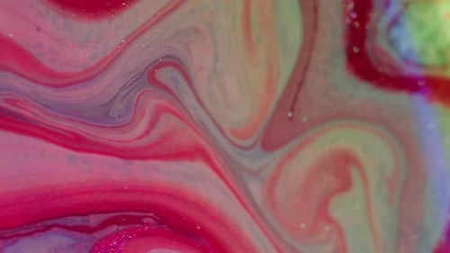 Swirling abstract liquid of pink, red, and blue