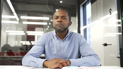 Webcam view. African american businessman watching video call conference looking at camera while