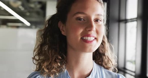 Portrait of happy caucasian casual businesswoman in office, slow motion