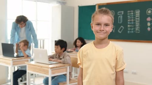 Caucasian student looking at camera while friend studying about code. Pedagogy.