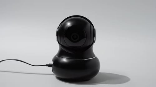 CCTV camera rotates the lens in different directions on a white background.