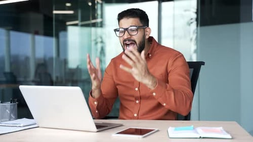 Frustrated Man Video Conferencing in Office Workplace