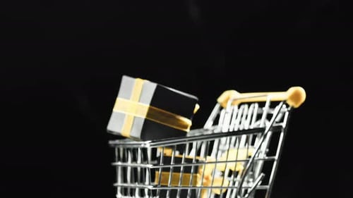 Gift Boxes Falling into Shopping Cart on Black