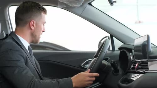 Man in Suit Inspecting Car Interior