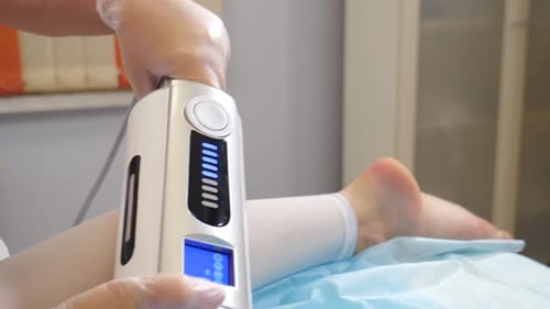 Health Professional Using Machine on Patient's Leg and Foot