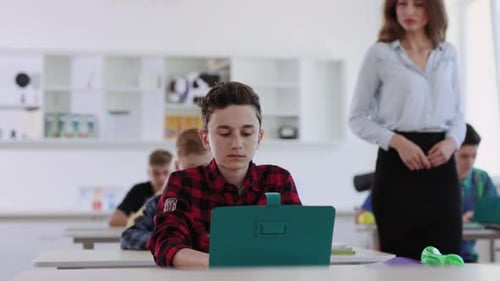 Students Are Engaged in the Learning Process with Their Laptops in a Classroom Setting