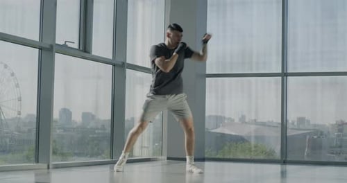Slow Motion of Mixed Martial Arts Fighter Training Alone Fighting Without Sparring Partner in Gym