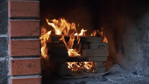 Firewood burning in the fireplace in slow motion
