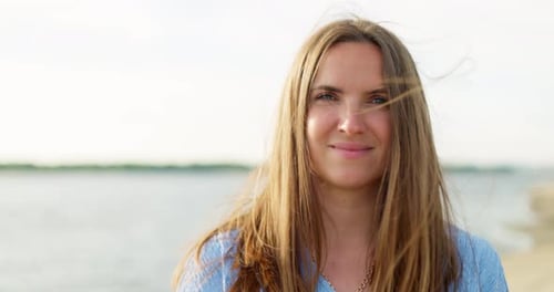 Woman with Long Hair Smiling by Water