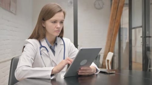 Young Doctor Using Tablet in Bright Office