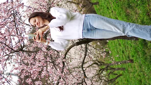 Lovely Young Woman Taking Photo of Blooming Pink and White Garden ...