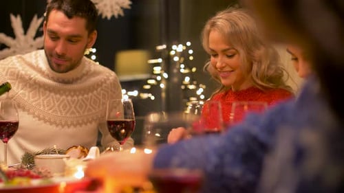 Friends Enjoying Festive Holiday Meal Together Indoors