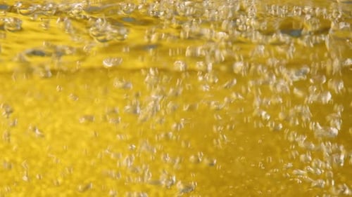 Bubbles Rising in Golden Liquid