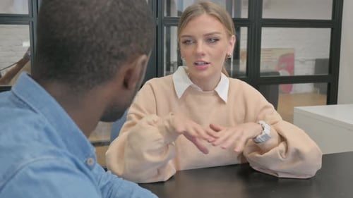 Business Discussion Between Two Adults in Modern Workplace