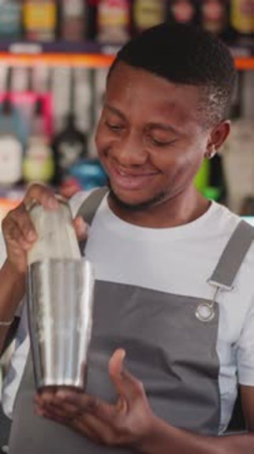 Smiling Bartender Shakes Silver Cocktail Shaker