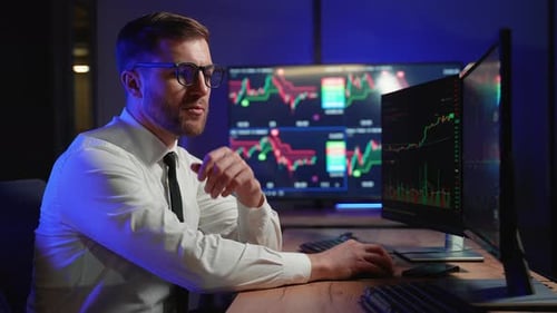 Side View Of Stock Market Broker Analyzing Candles Graphs On Multiple Computer Screens Concept Of