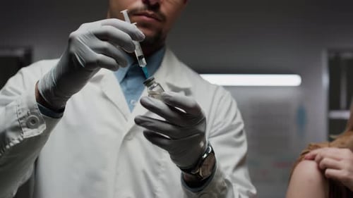 Medical Professional Preparing Injection in Clinic