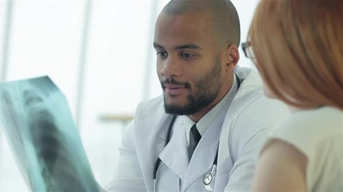 Doctor Reviewing X-Ray with Patient in Office