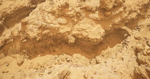 Rocky Terrain Revealing Layers of Sediment in a Desert Landscape