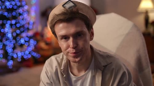 Thoughtful Young Man Sipping Champagne at Christmas
