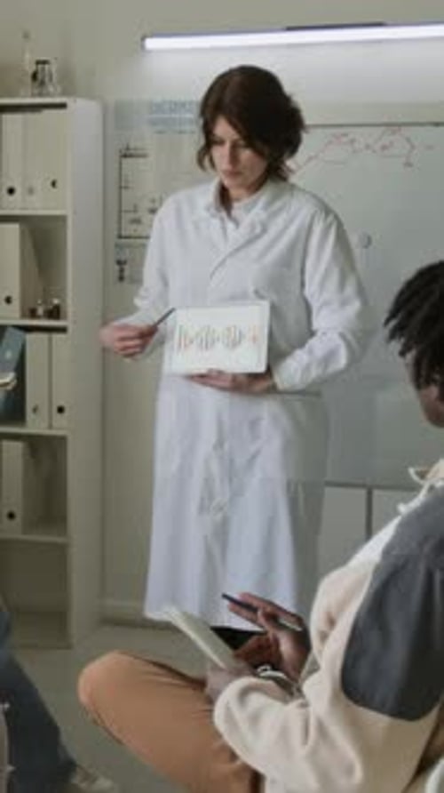 Woman Explains Science to Students in Classroom